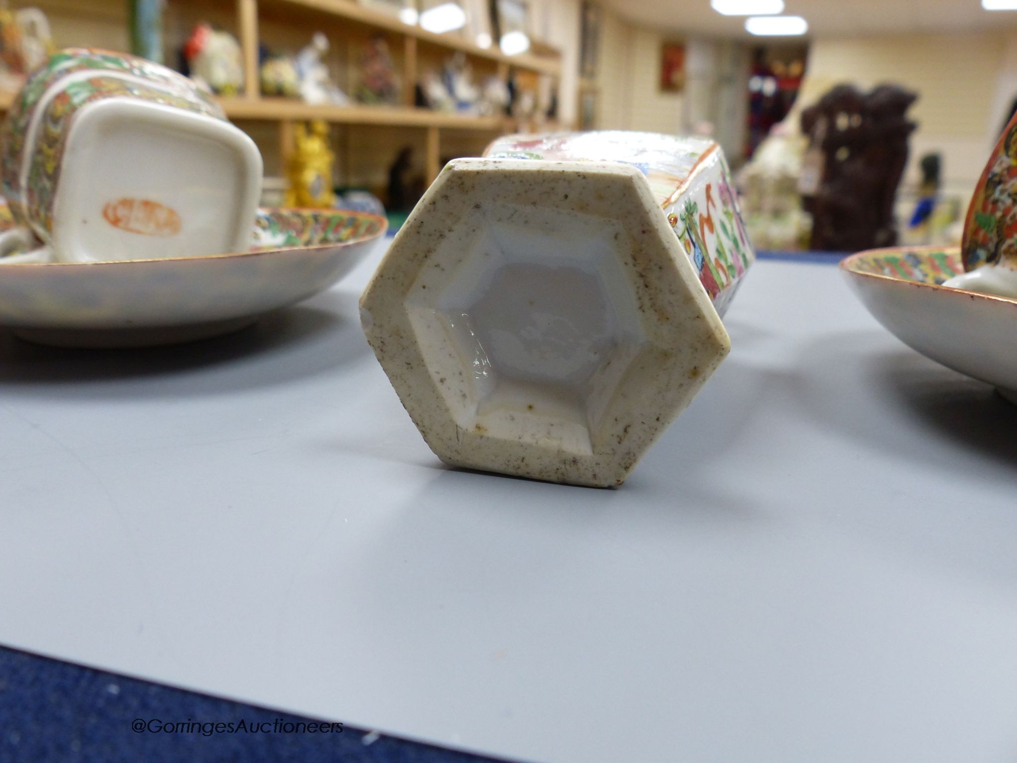 A Chinese famille rose small vase and two cups and saucers